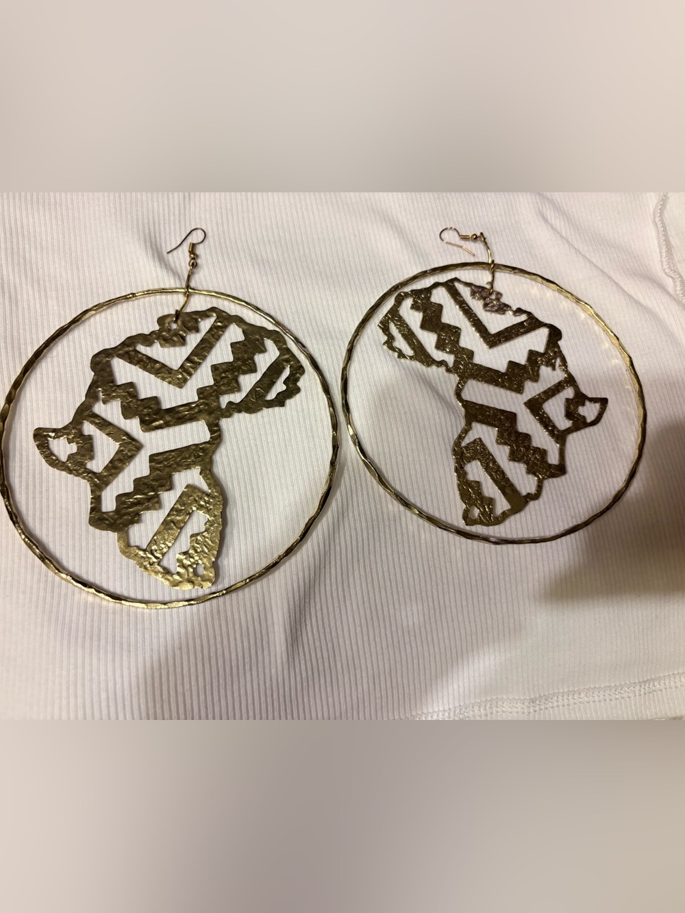 Gold Tone Africa Map Hoop Earrings.
